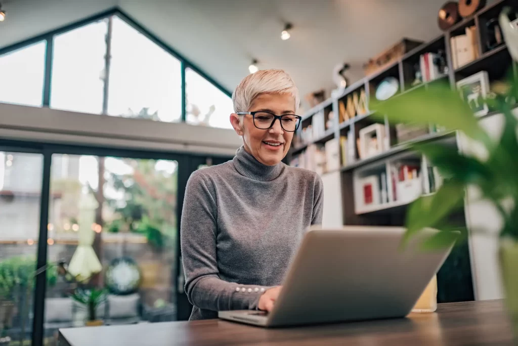 Online functional medicine consultation Woman taking part in an online functional medicine consultation from home using a laptop
