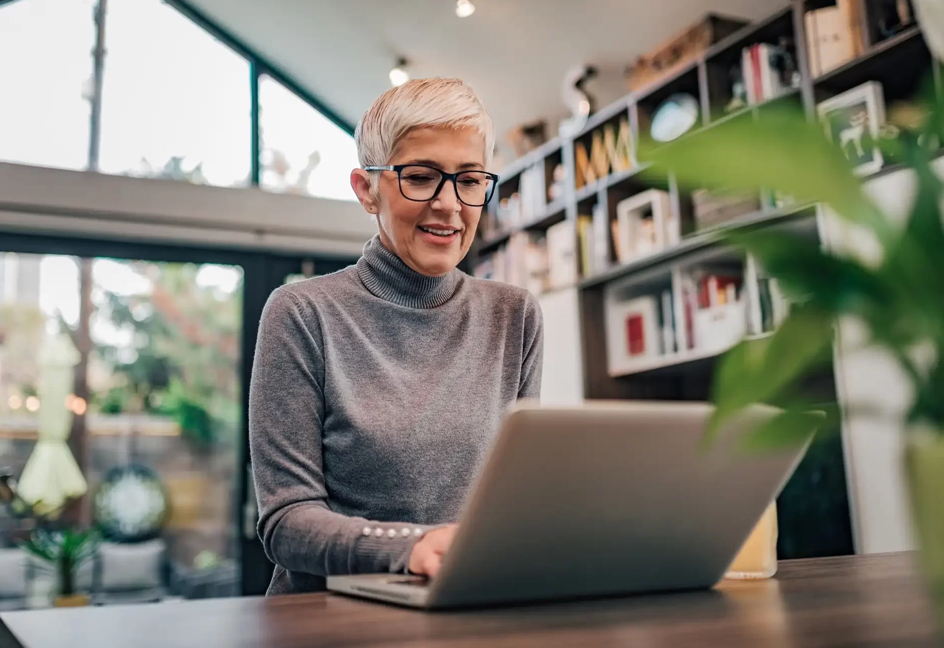 Woman taking part in an online functional medicine consultation from home using a laptop