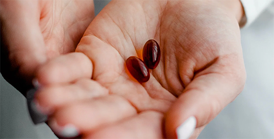 Targeted Supplementation for Mitochondrial Support Person holding supplements used to support mitochondrial energy production and cellular repair