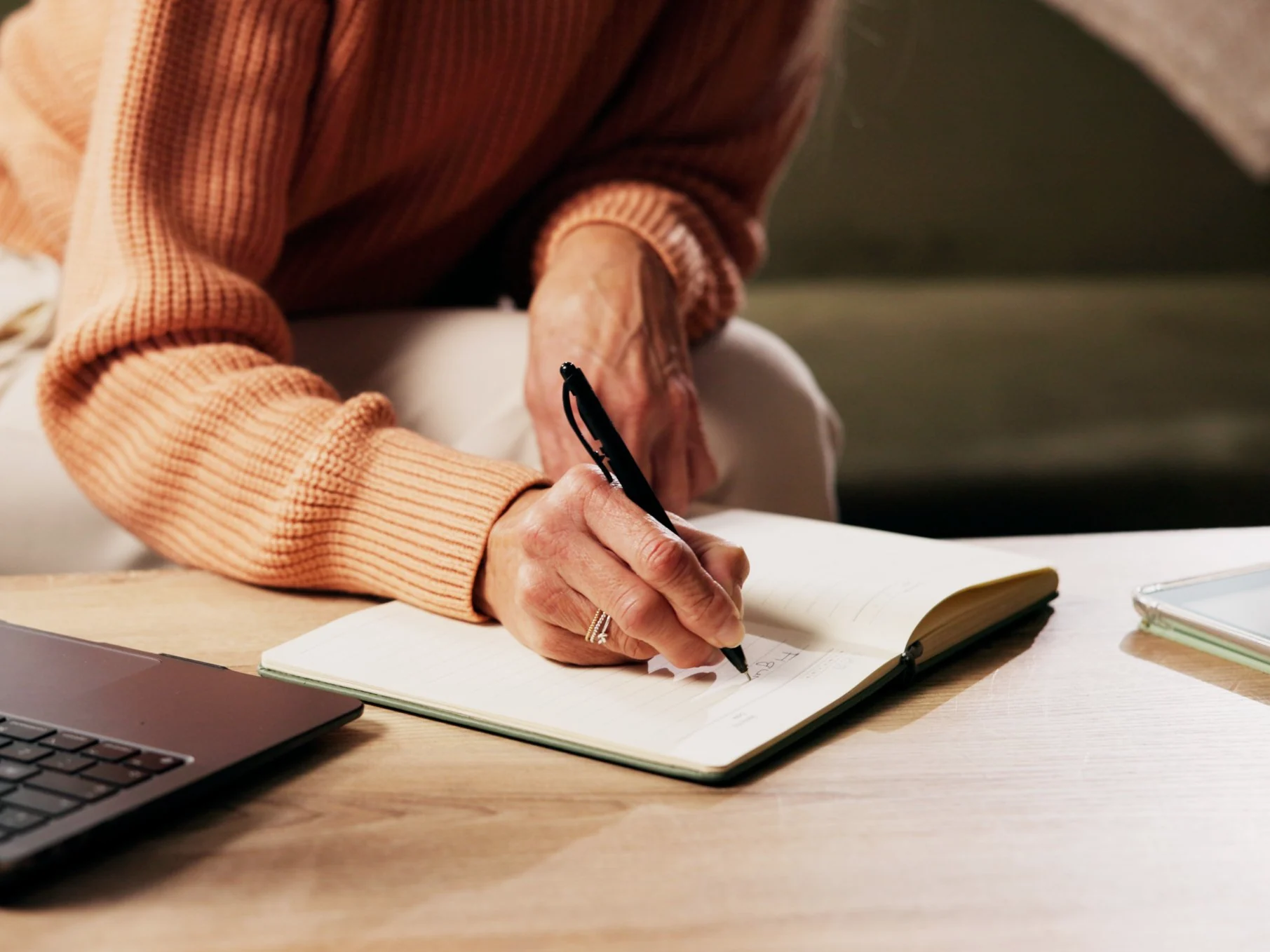 Woman writing in a food and symptom diary at home, the simplest first step in testing for food sensitivities